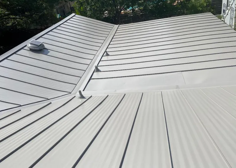 Solar attic fan installed on a metal roof for Roof Ventilation in Heathrow