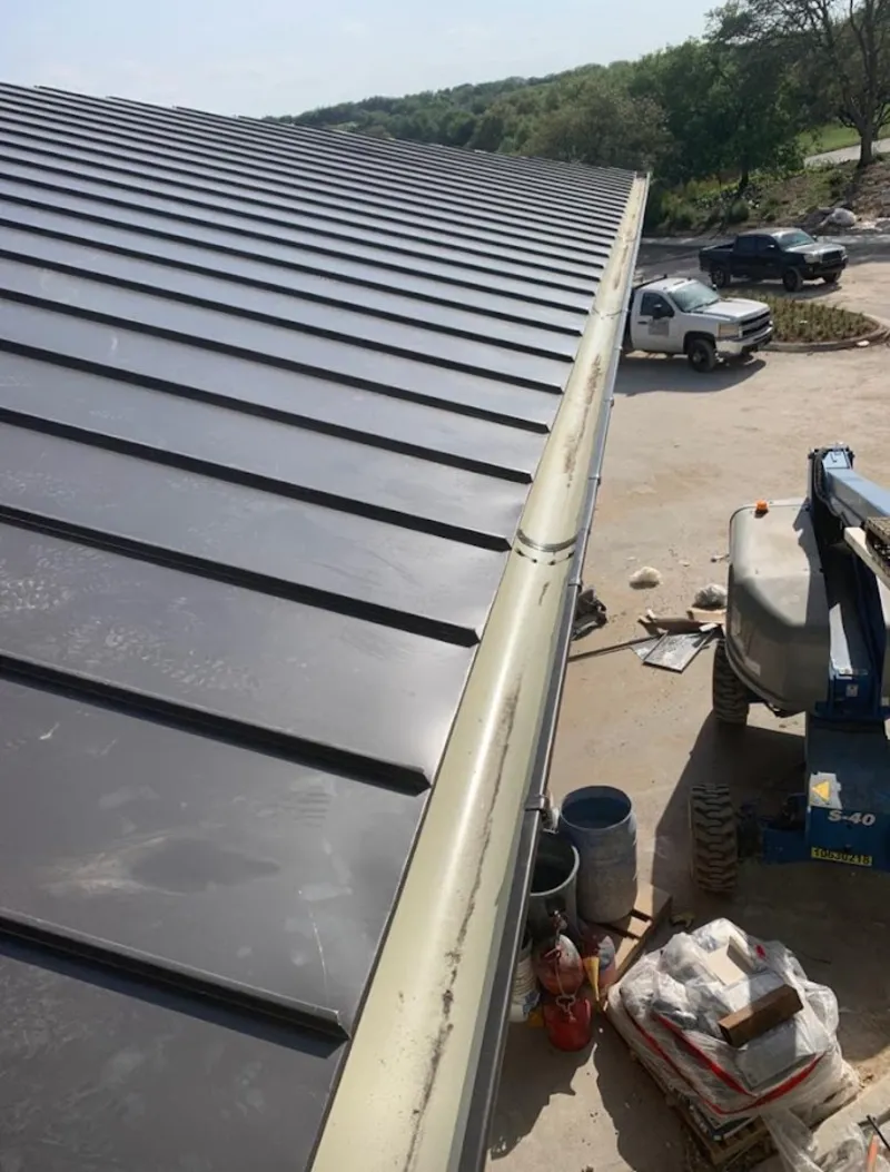 Standing seam panel and gutter detail on a metal roofing jobsite in Heathrow